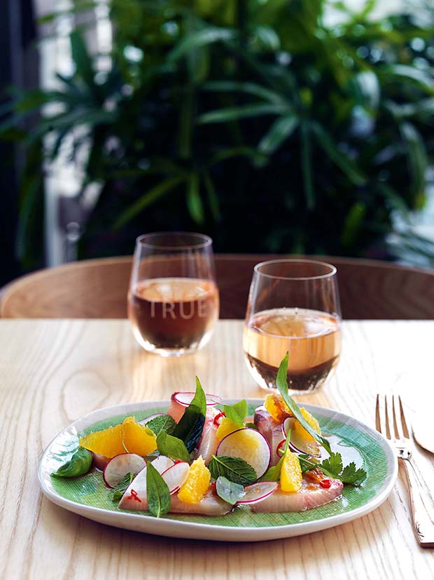 The True Tiradito Salad is a zesty tossed Peruvian sashimi dish made with kingfish, apple, grapefruit radish and chilli.