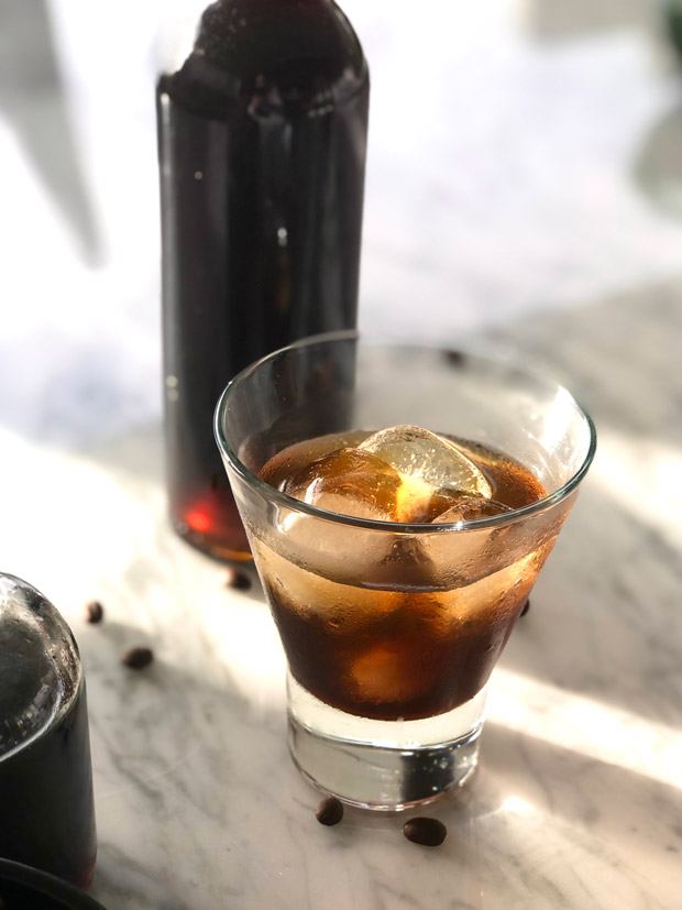 Homemade coffee liqueur served over ice in a glass. 